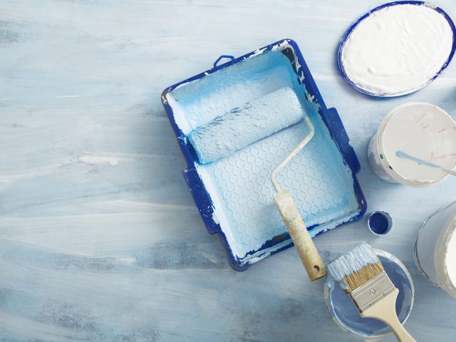 Painting tools for apartment renovation on blue background